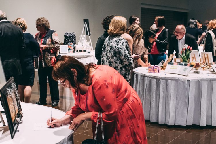 Silent auction tables at We Believe 2019