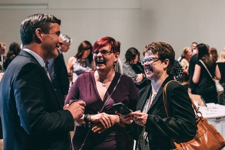 Guests sharing a laugh at We Believe 2019.