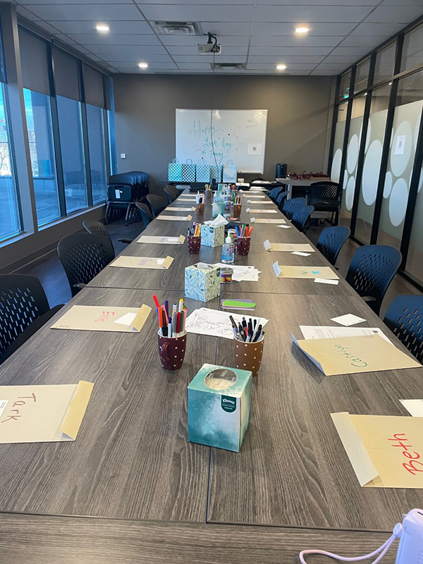 2022 Fall SIL Commencement Volunteer Services program materials are arranged on the tables of the SACE boardroom along with gift bags and prepared activities for the fall SIL commencement.