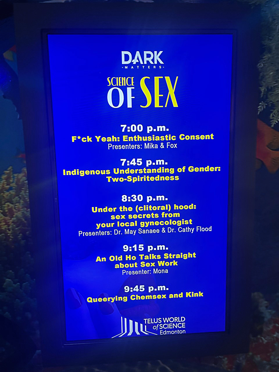 Dark Matters line up of events for the evening at Telus World of Science Edmonton is displayed on a digital screen.