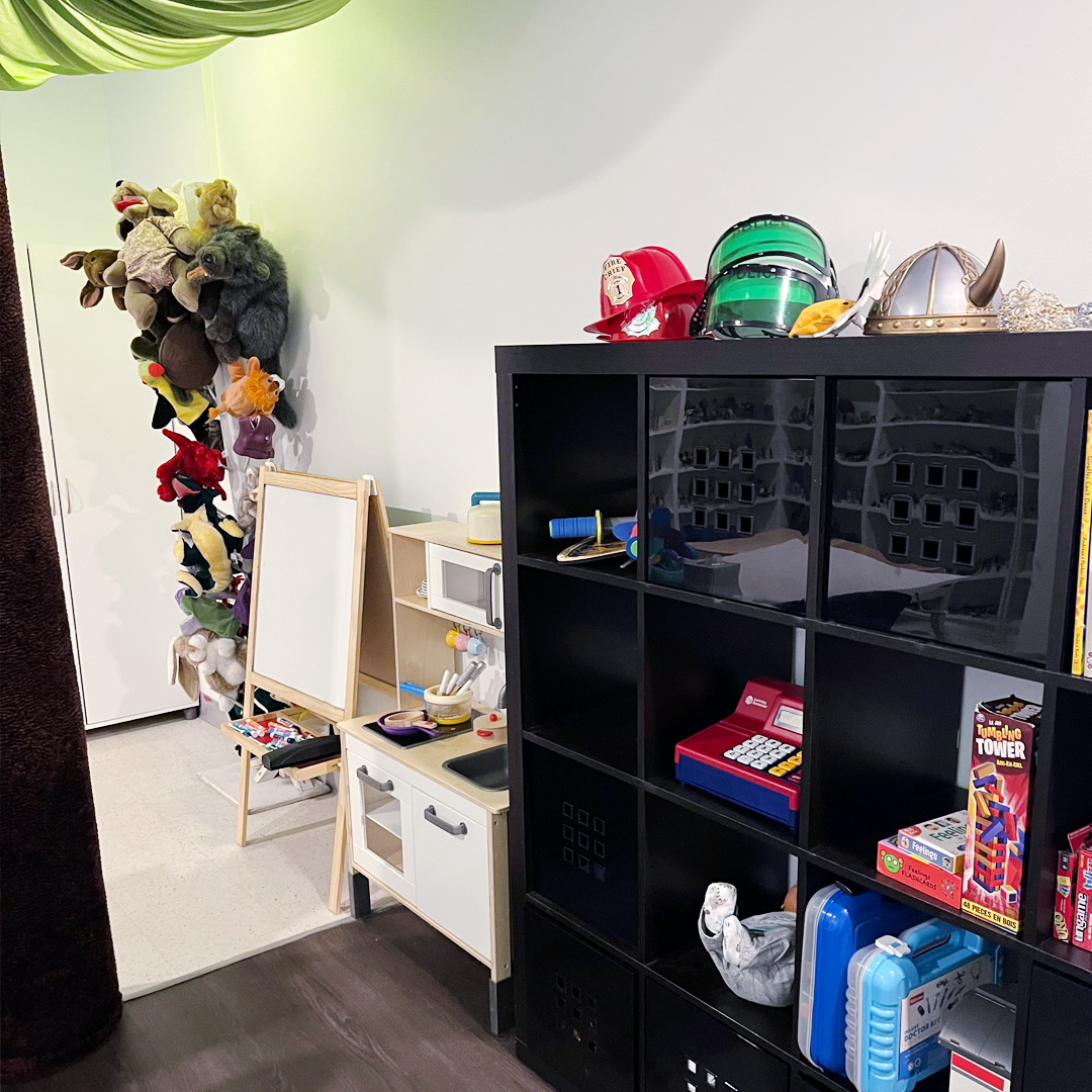 SACE playroom with stuffed animals, costumes and play therapy toys