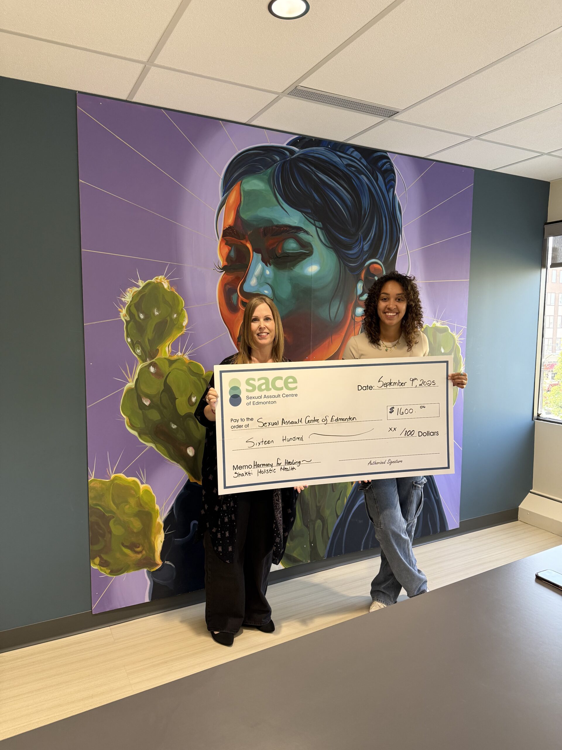 Harmony for Healing Event by Shakti Holistic Health Cheque Presentation scaled - How We're Making a Difference 2025-2026